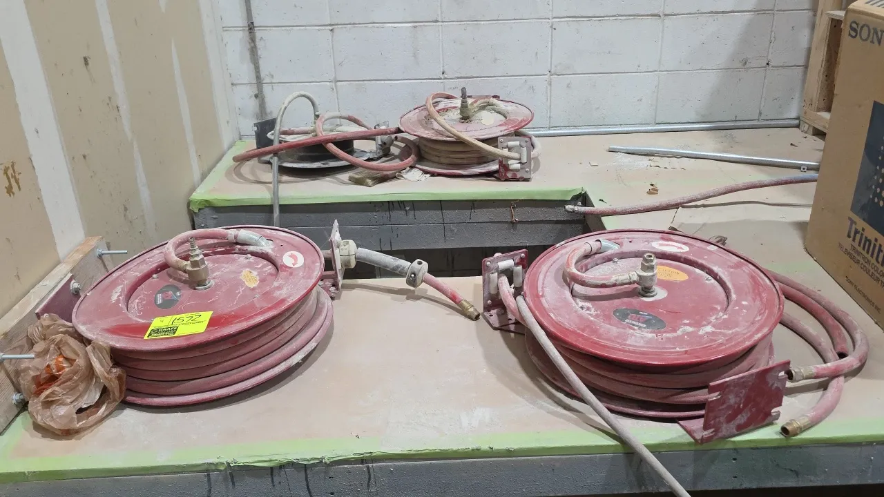 Metal retractable air hose reels, including ATD. Features spring-driven automatic rewind mechanisms, fitted air hoses with hose stops, four-roller gui