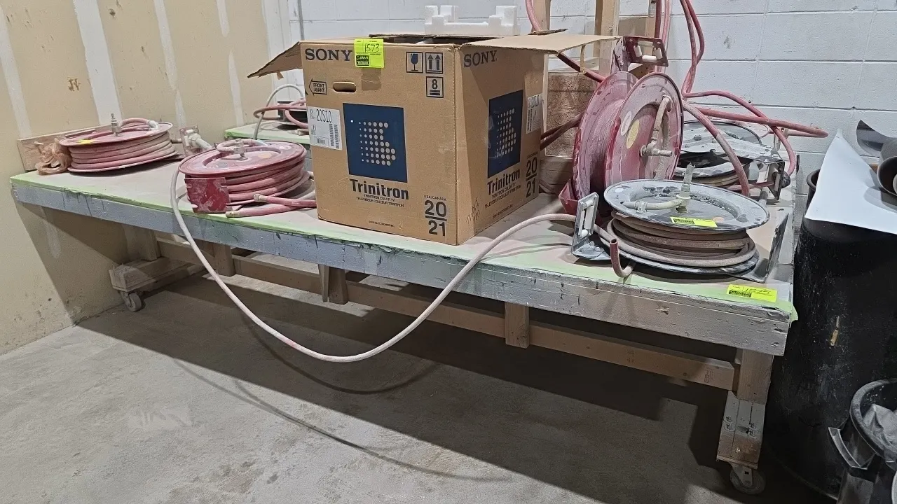 Portable wood work table. Features wood construction with a 48" x 24" U-shape opening. Dimensions: 120" x 72". Mounted on casters. Contents not includ