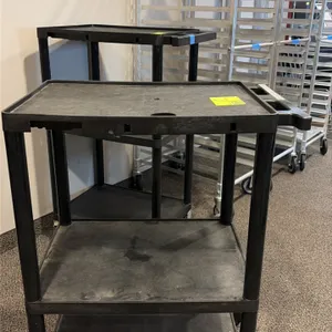 Polymer 3-tier portable utility cart. Molded black plastic construction featuring three shelves with retaining lip borders and integrated push handle.