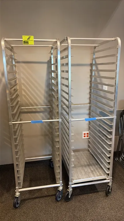 Aluminum front-load channel pan racks. Features aluminum tubular frame construction with channel slide runners. Mounted on swivel casters.