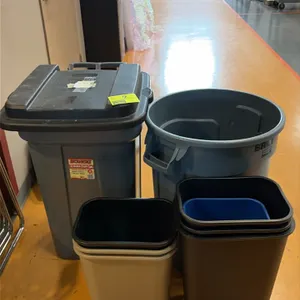 Assorted trash cans and wastebaskets. Includes Rubbermaid Roughneck wheeled trash can with lid, Rubbermaid Brute round container, and assorted nested 