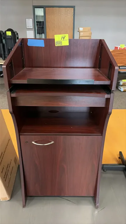 Oklahoma Sound Aristocrat floor sound lectern. Features woodgrain laminate construction, slanted reading surface with book stop, pull-out shelf, open
