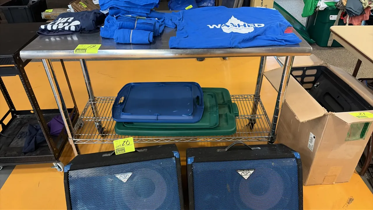 Stainless steel work table. Features a stainless steel top with rolled rim and an adjustable wire undershelf. 4'L. Mounted on casters. Contents not in