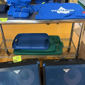 Stainless steel work table. Features a stainless steel top with rolled rim and an adjustable wire undershelf. 4'L. Mounted on casters. Contents not in