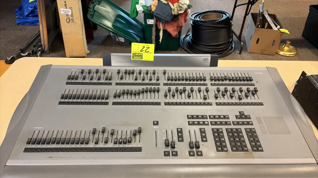 ETC Express 48/96 lighting control console. Features two-tier channel faders, 24 submasters, dual timed crossfaders, numeric keypad, and LCD display p