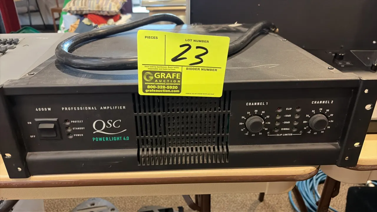 QSC PowerLight 4.0 4000W 2-channel professional power amplifier. Features dual-channel rotary level controls, LED status indicators, and integrated ra