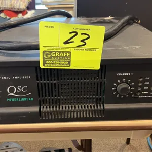 QSC PowerLight 4.0 4000W 2-channel professional power amplifier. Features dual-channel rotary level controls, LED status indicators, and integrated ra
