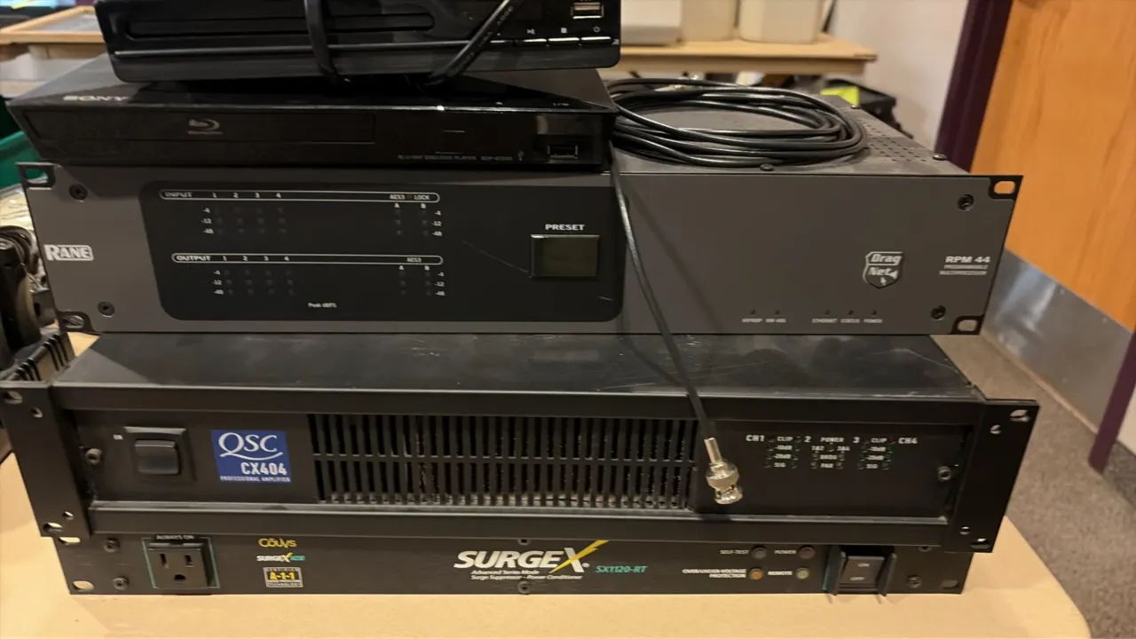 Audio and video equipment lot. Includes a Jinhoo DVD/CD player, Sony Blu-ray/DVD player, Rane RPM 44 programmable multiprocessor, QSC CX404 4-channel