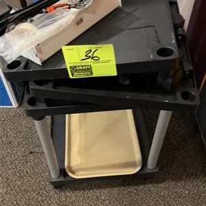 Plastic utility cart with assorted tools and parts. Features molded plastic shelving and swivel casters. Includes cable ties, hand tools, and assorted