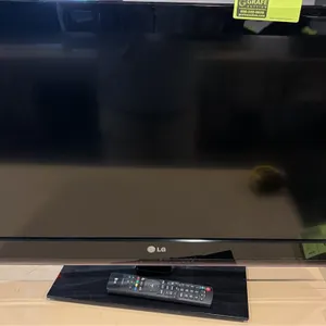 LG 32" flatscreen TV. Includes remote control. Mounted on tabletop stand. Note: Power cord is not included.