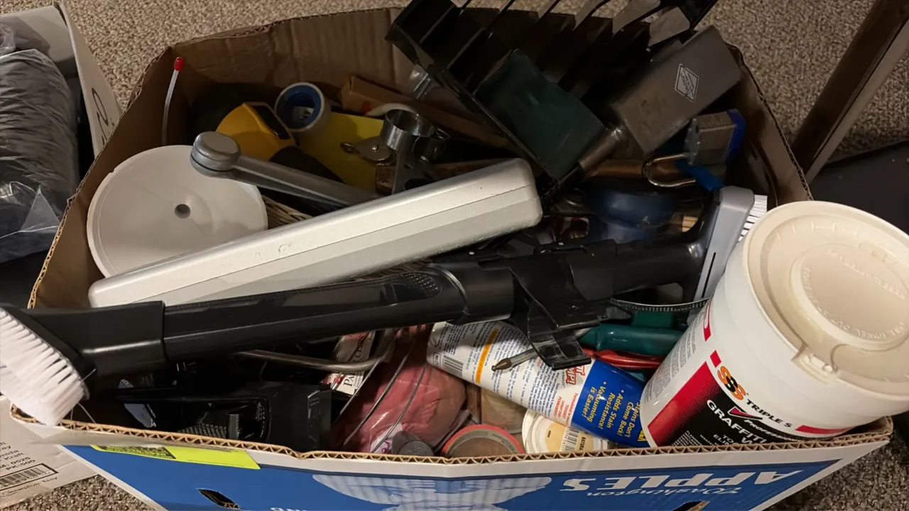 Box lot of assorted cleaning and maintenance supplies. Includes Triple S wipes container, scrub brush attachment, door closer mechanism, flashlight, p