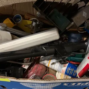 Box lot of assorted cleaning and maintenance supplies. Includes Triple S wipes container, scrub brush attachment, door closer mechanism, flashlight, p