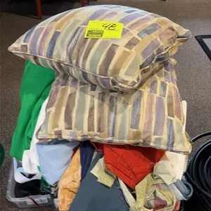 Assorted textiles, clothing, and pillows. Includes (2) patterned throw pillows, assorted fabric remnants and linens, and plastic storage containers.