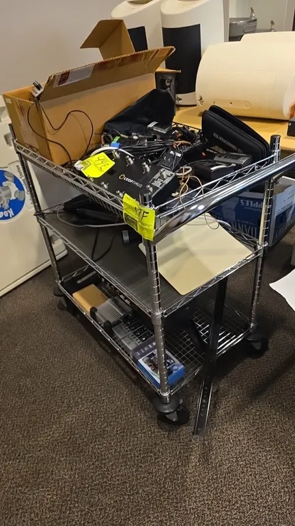 Chrome 3-tier wire utility cart. Features (3) wire shelves and an integrated tubular push handle. Mounted on swivel casters with donut bumpers. 30"L x