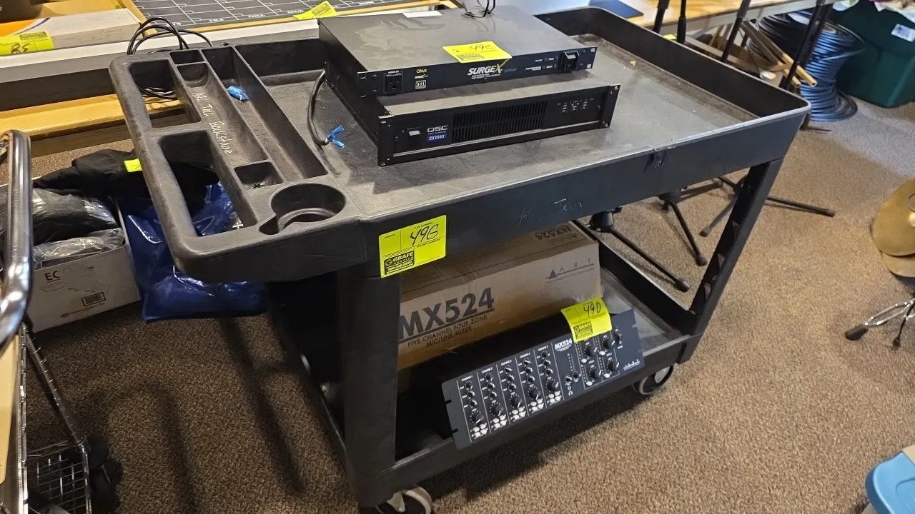 Polymer 2-tier utility cart. Features molded handle with integrated tool compartments and cup holder, and two lipped shelves. 25.75" x 45". Mounted on