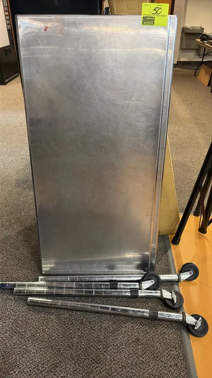Stainless steel work tables. Includes (2) 48" x 24" stainless steel tops and (4) chrome post legs with casters. Note: One unit does not have legs.