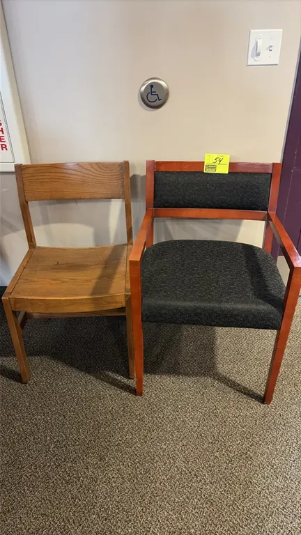 Assorted office chairs. Includes a solid wood side chair, a wood-frame armchair with dark fabric upholstery, a metal-frame armless stacking chair, and