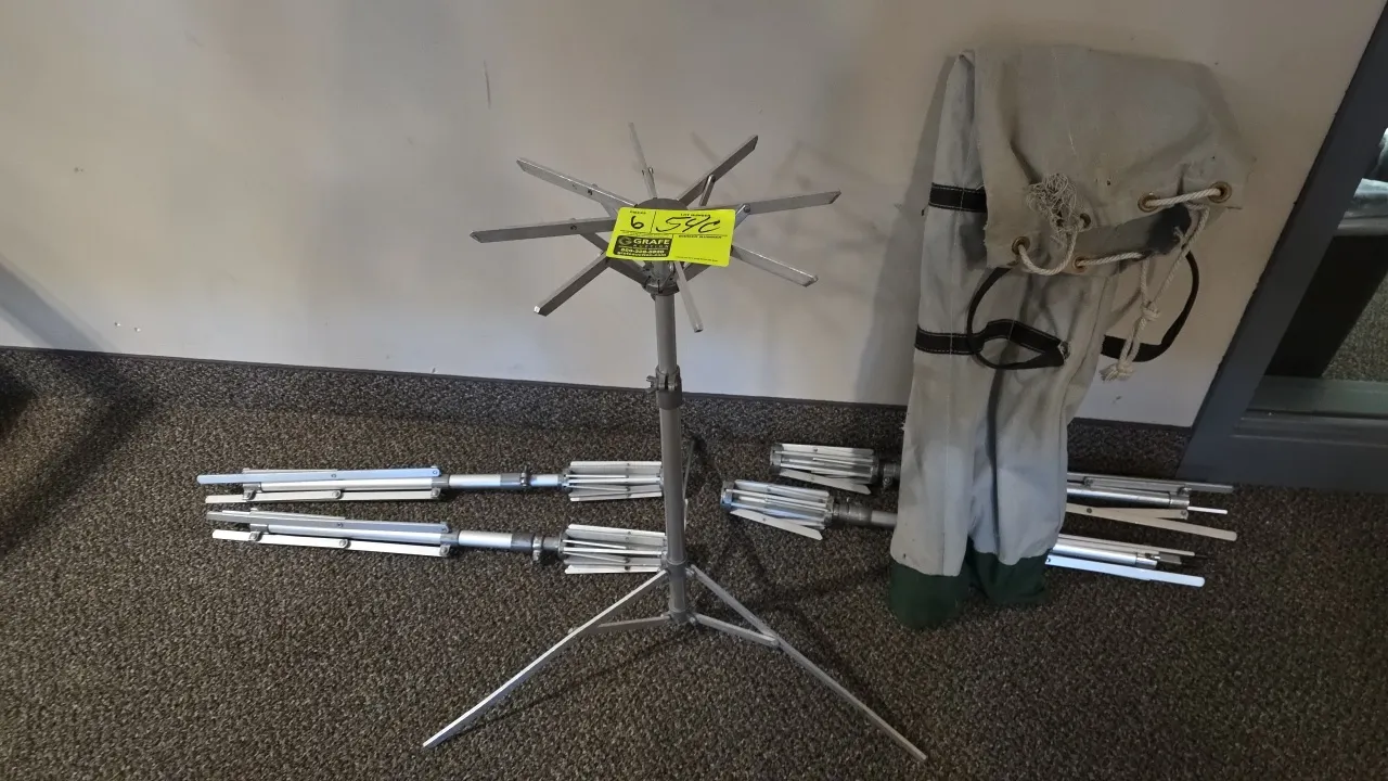 Aluminum folding floral stands. Features adjustable height telescoping poles, folding tripod bases, and collapsible top support arms. Includes canvas