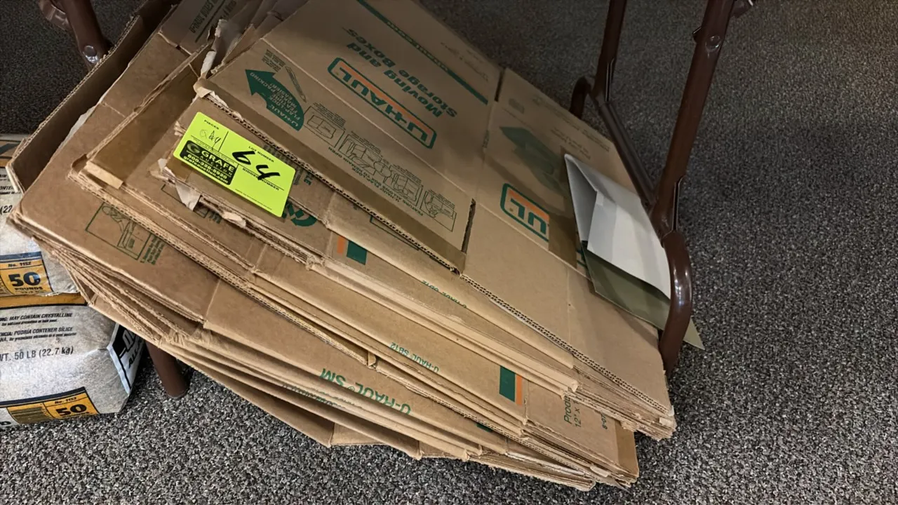 U-Haul corrugated cardboard moving boxes. Assorted stack of flattened moving and storage boxes. Note: Table and surrounding background items not inclu