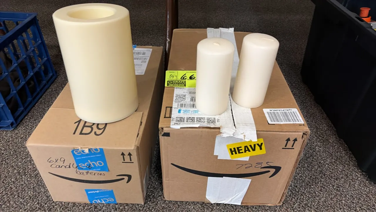 Assorted lot of wax candles and battery-operated candles. Includes flameless battery-operated pillar candle and traditional wax pillar candles with st