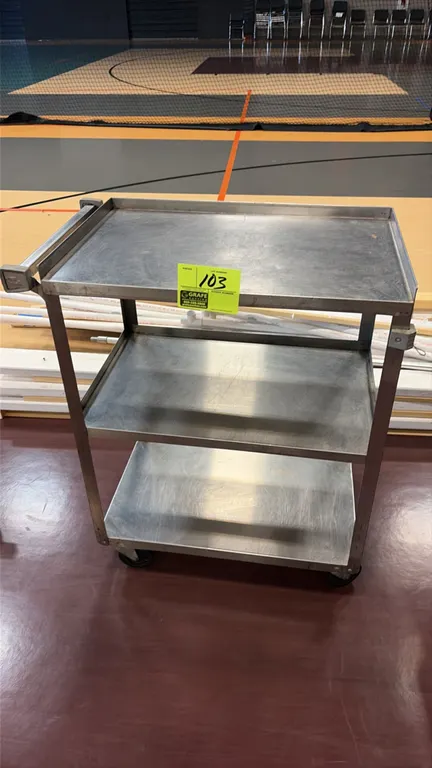 Stainless steel 3-tier utility cart. Features all-welded stainless steel construction, a top shelf with three-sided retaining lip, an integrated push