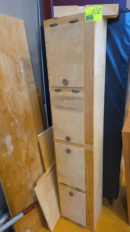Wood 4-door wall cabinet. Features plywood construction, 4 hinged doors with wood pull knobs, divided interior compartments, and an open back design.