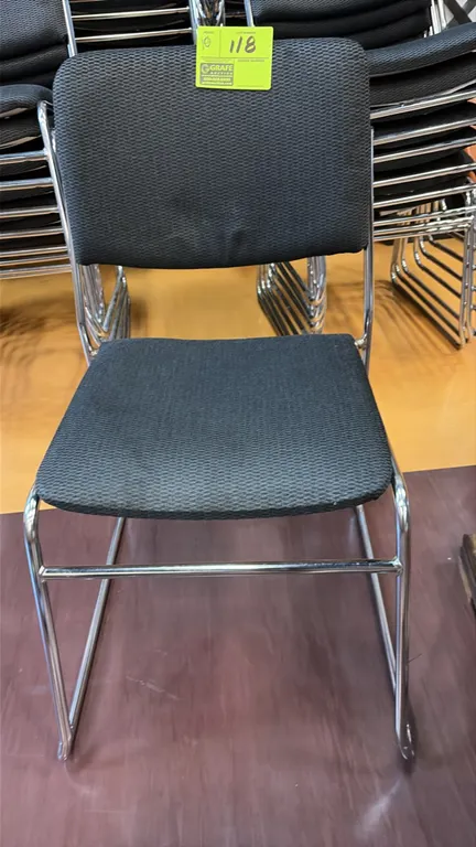 Cloth stack chairs. Features gray textured fabric upholstered seat and backrest. Mounted on a chrome tubular sled base frame. Stackable design.