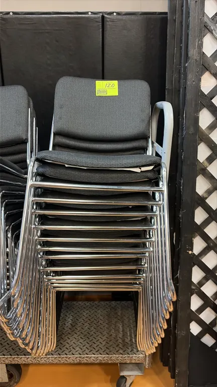 Gray cloth stacking chairs. Features upholstered seats and backs with chrome sled base frames. Stackable design. Cart not included.
