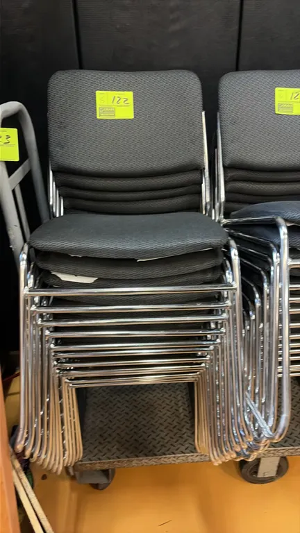 Gray cloth stack chairs. Features gray patterned fabric upholstered seat and backrest, and an armless design. Mounted on chrome-plated tubular metal s