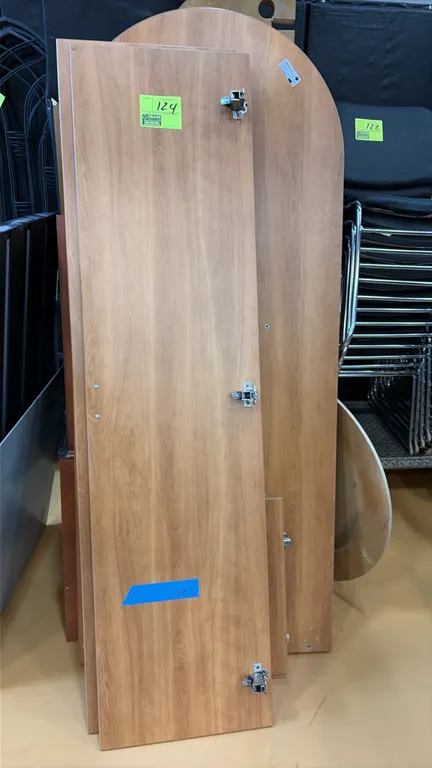 Wall-mounted desk components. Features woodgrain laminate finish, cabinet doors with concealed European hinges, and a rounded desktop panel.