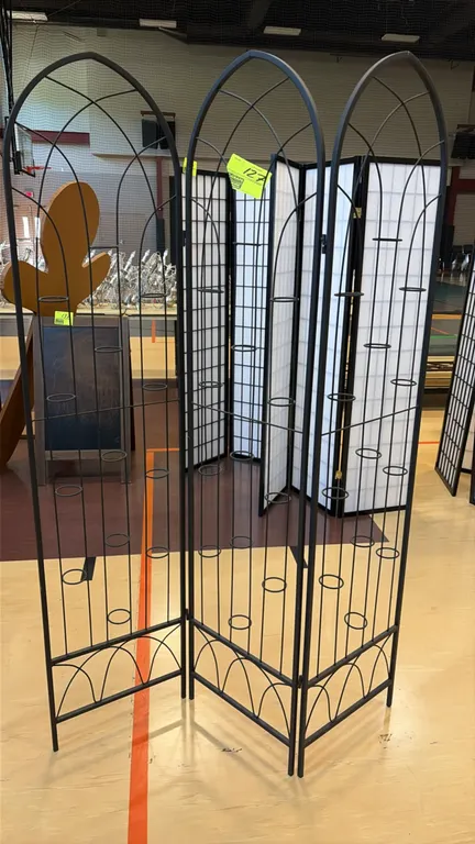 Black metal 3-panel folding floral and candle screen. Features arched trellis design with integrated circular ring holders throughout for floral or ca