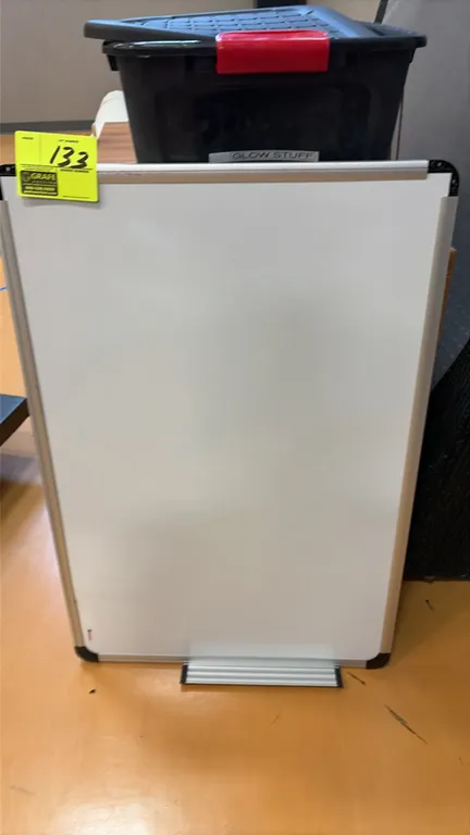 Dry erase whiteboard. Features aluminum frame with corner protectors and integrated marker tray. Dimensions: 2' x 3'. Tote in background not included.