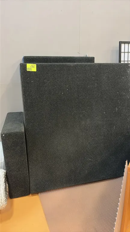 Assorted carpeted stage risers. Features charcoal ribbed commercial carpet covering and solid frame construction in varied modular sizes.