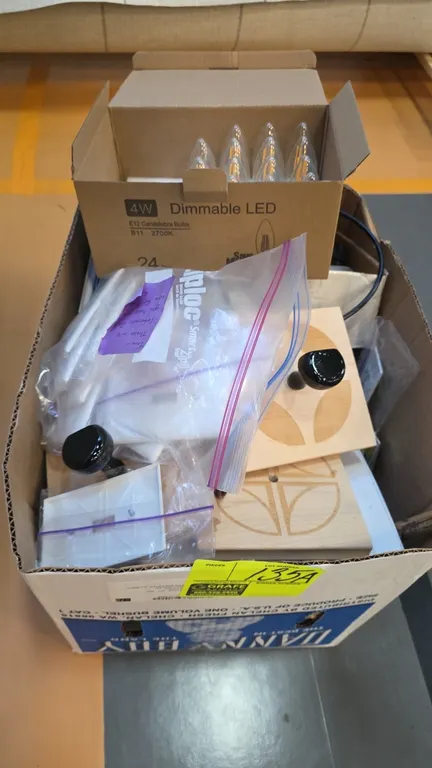 Assorted electrical components and hardware. Includes a box of 4W dimmable LED candelabra bulbs (E12, B11, 2700K), GFCI receptacles, wall switch plate