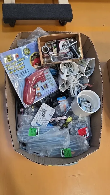 Assorted hardware and tool lot. Includes Light Keeper Pro incandescent light set repair tool, Black & Decker 12V battery component, zinc-plated and ga