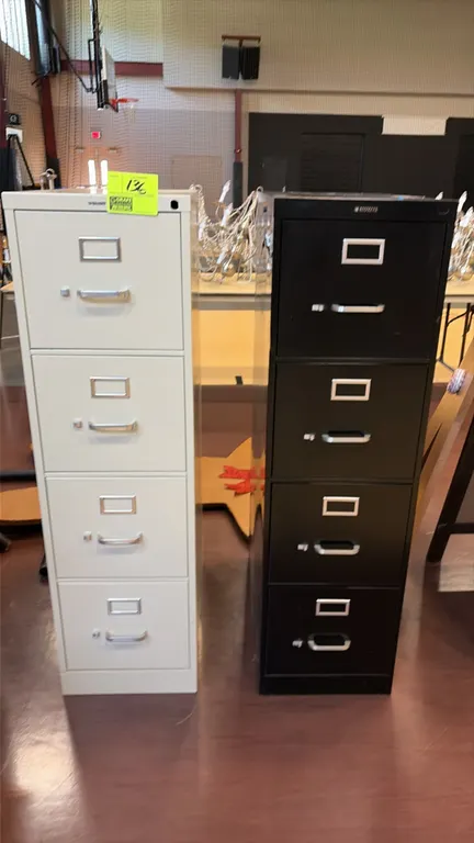Metal 4-drawer vertical file cabinets. Includes (1) putty-colored and (1) black 4-drawer file cabinet. Features steel construction, pull handles, and