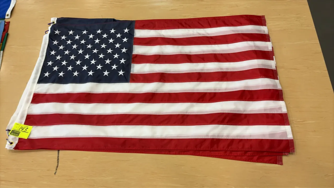 United States of America flags. Features sewn stripes, embroidered stars, and a reinforced canvas header with brass grommets.