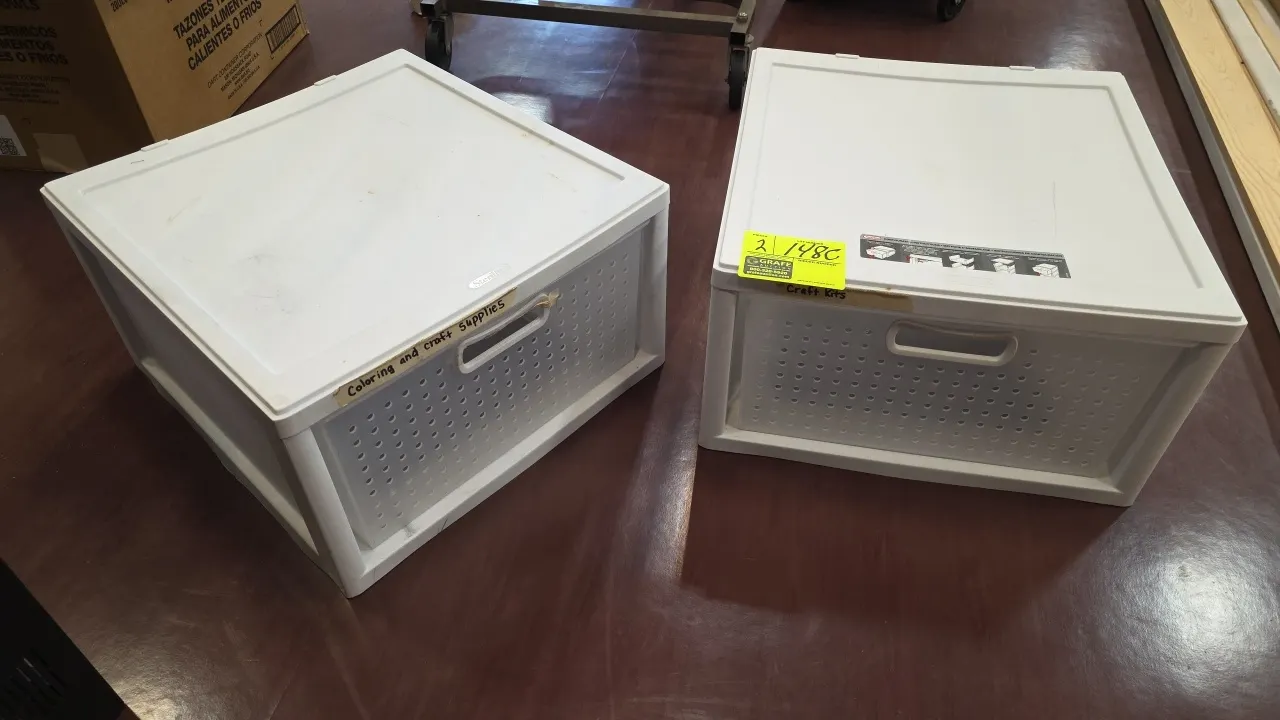 Sterilite stackable plastic storage drawers. Features modular stackable design with pull-out drawers and integrated handles. White plastic constructio