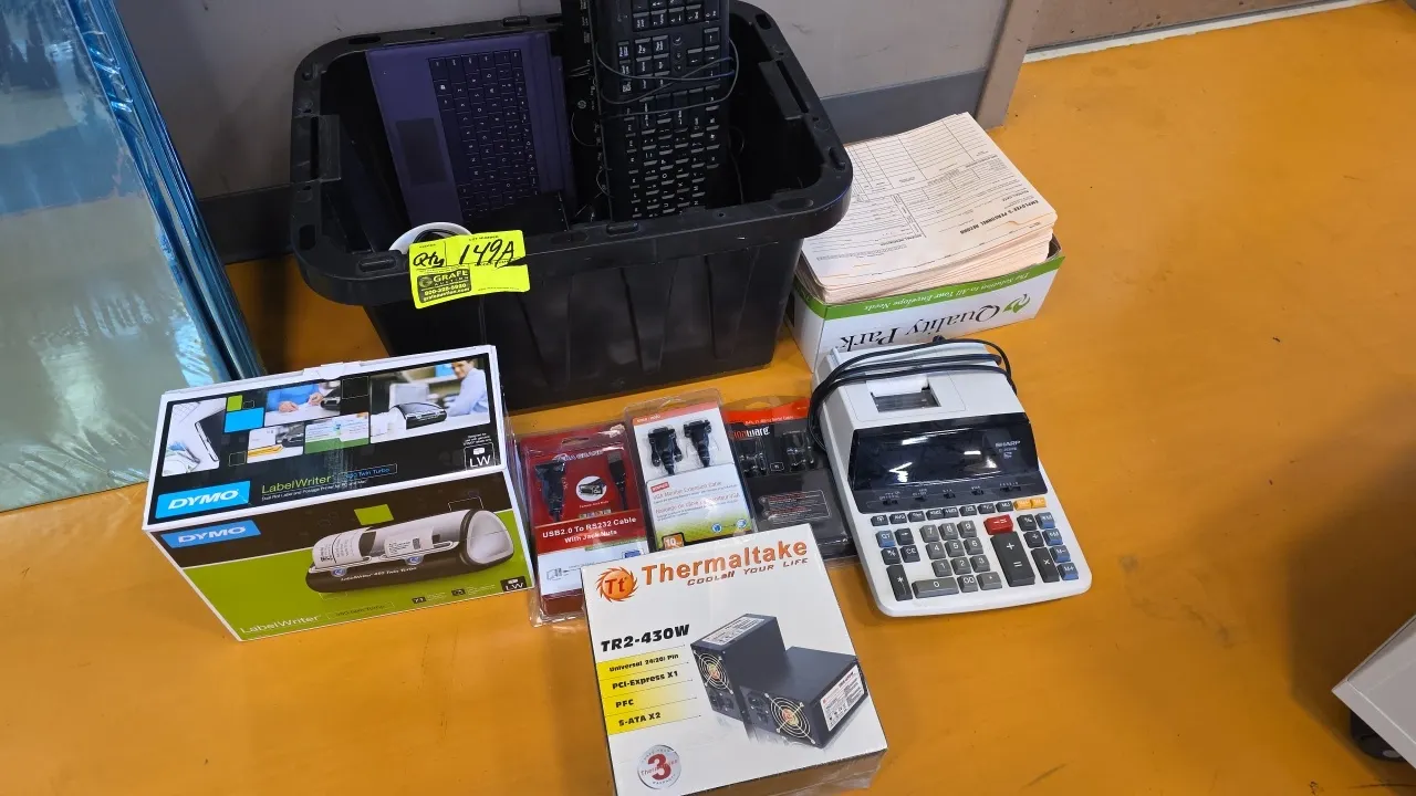 Office and computer accessories lot. Includes black plastic storage tote, assorted computer keyboards, Dymo LabelWriter 450 Twin Turbo label printer i