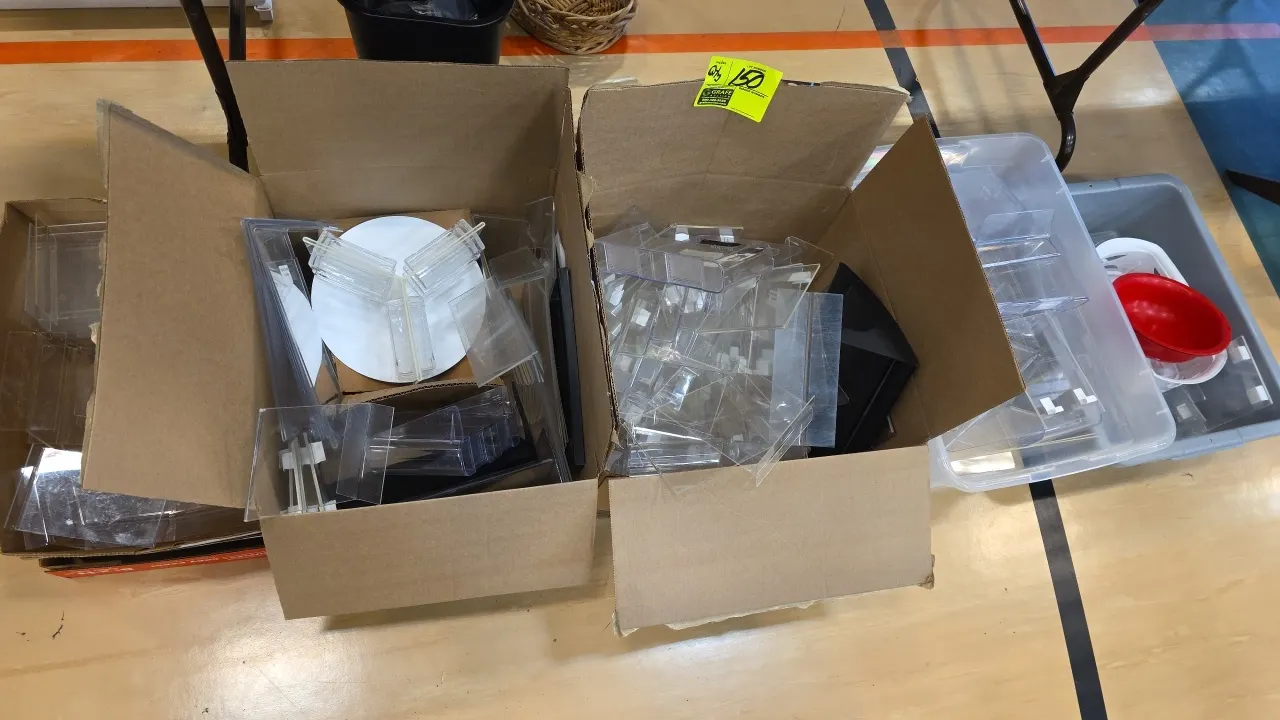 Assorted office organizers and acrylic displays. Includes clear acrylic sign holders, literature racks, tiered desktop holders, small plastic containe