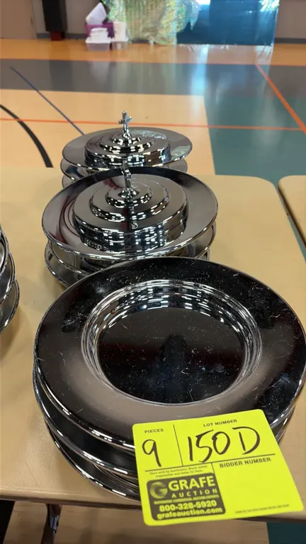 Stainless steel communion platters. Features a polished finish, stackable rim design, and covers with cross finials. Dimensions: 10"Dia.