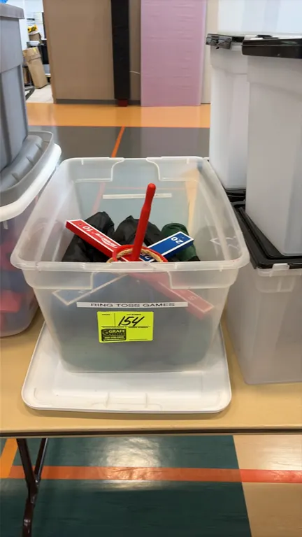 Ring toss games. Includes wooden cross targets with point markings, target pegs, rope and plastic rings, and zippered storage bags. Housed in a clear
