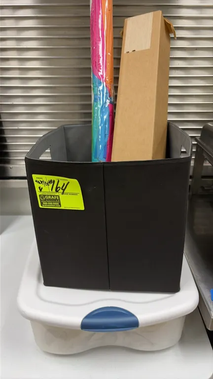Assorted office supplies and miscellaneous items. Includes electric paper shredder, plastic storage totes, fabric storage cube, 3-ring binders, folder