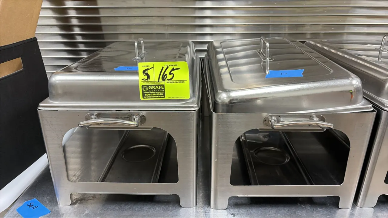 Stainless steel Sterno chafing dish bases. Features stainless steel construction, integrated side handles, lower fuel holder trays, and lift-off recta