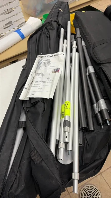 Banner stand frame assembly. Includes telescoping vertical and horizontal poles, hardware, zippered carry cases, and assembly instructions. Configurab
