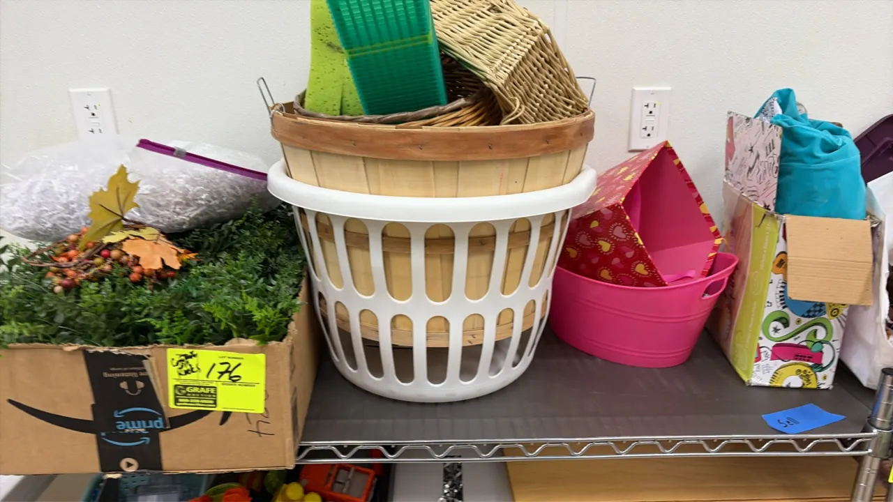 Assorted storage, decorative, and household contents. Includes plastic organizer caddies, storage bins, woven and bushel baskets, artificial foliage,