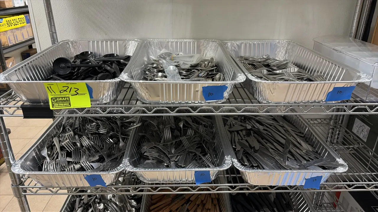Assorted flatware and utensils. Includes stainless steel forks, knives, and spoons, wood-handled steak knives, plastic-handled steak knives, and assor