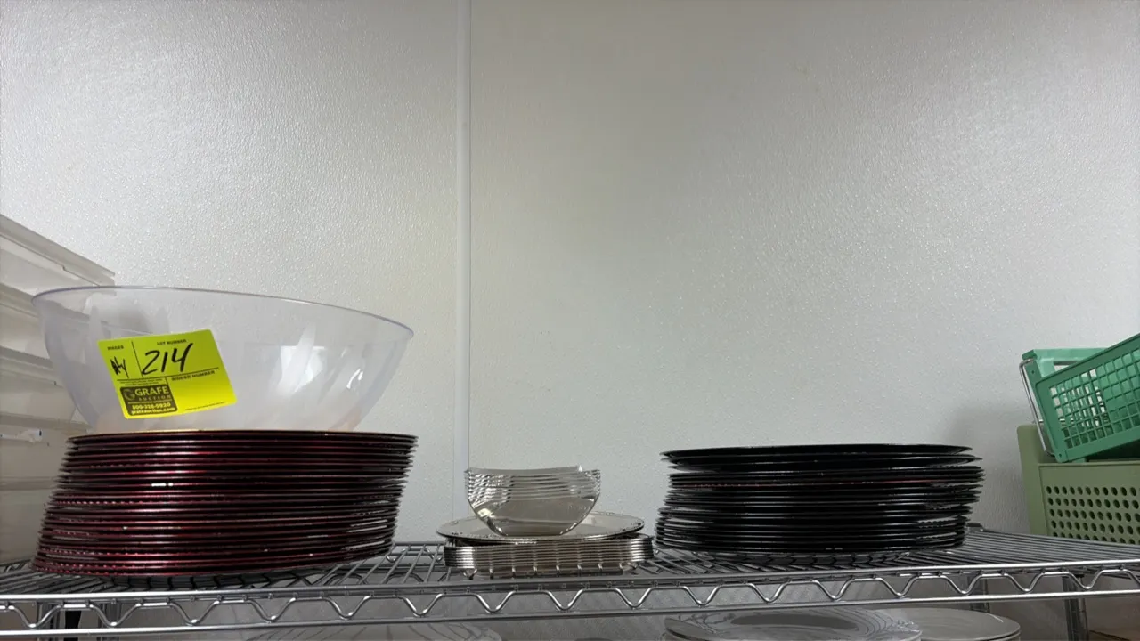 Assorted serving trays and bowls. Includes a clear plastic serving bowl, stacks of round serving trays and platters, small rectangular trays, and smal