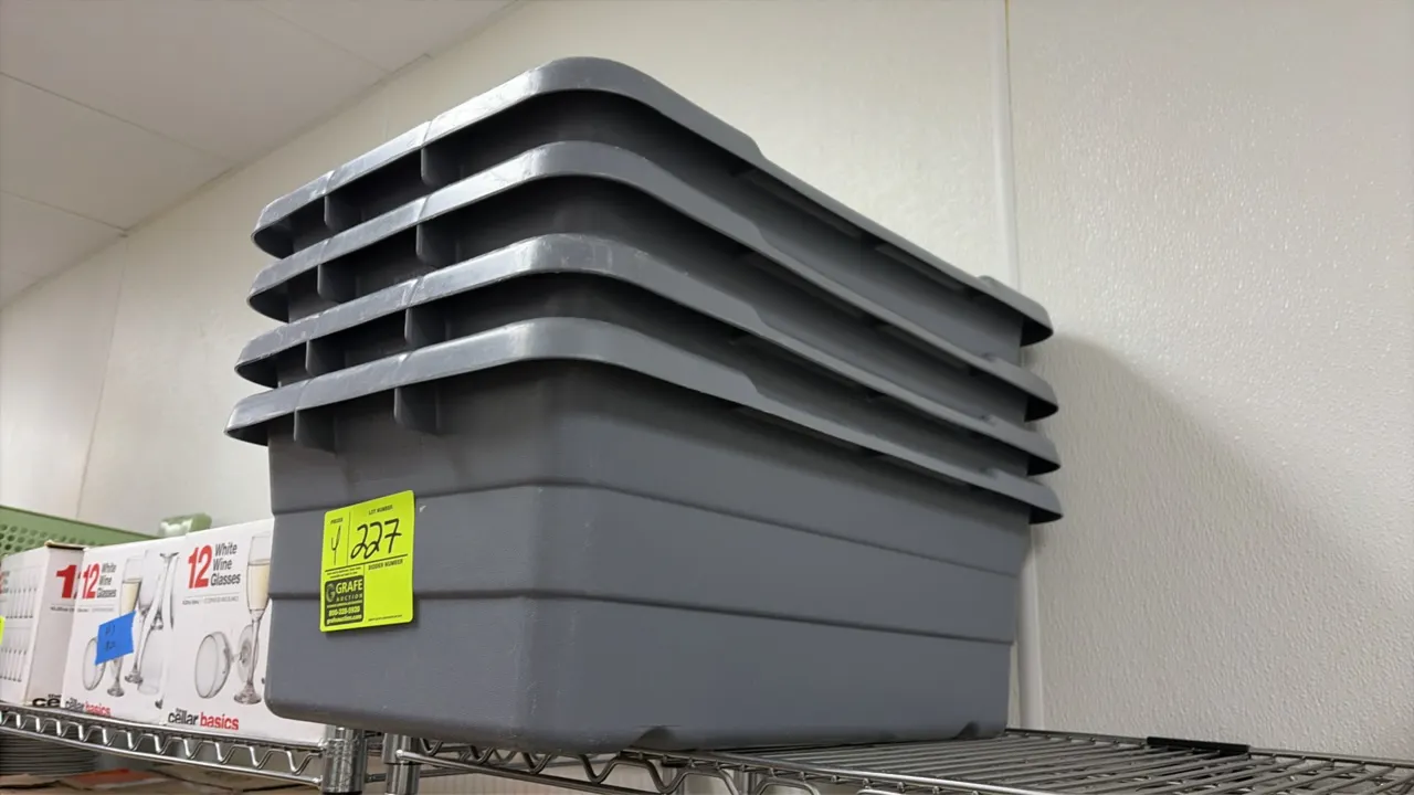 Poly luggers. Features gray molded polyethylene construction, reinforced rim with integrated handles, and stackable nesting design.