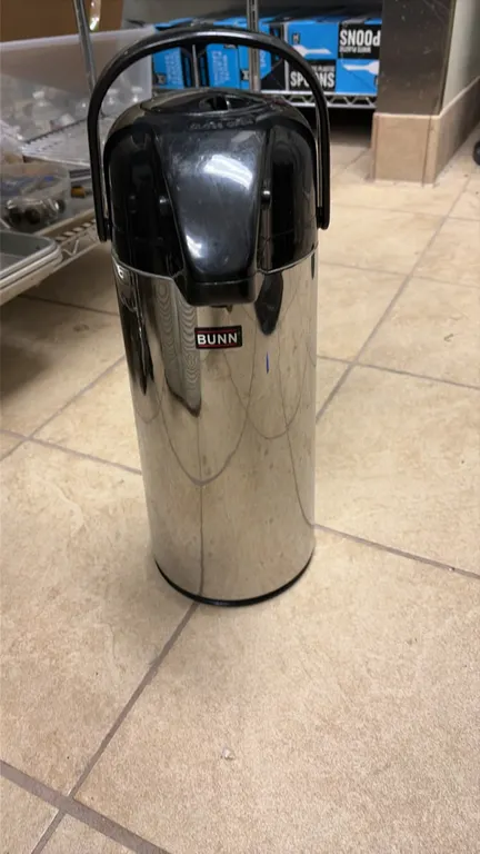 Bunn stainless steel thermal airpots. Features insulated stainless steel bodies, lever-action dispensing mechanisms, integrated carry handles, and dur